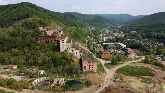 View from above. The camera flies past the abandoned plant of the Khrustalnensky mining and processing plant in the village of Khrustalny, Primorsky Territory. Abandoned tin mining plant