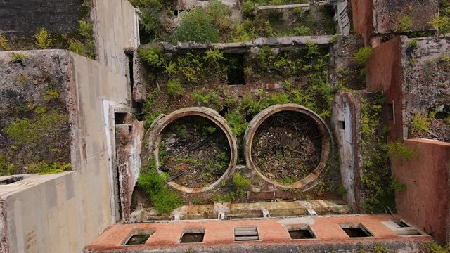 View from above. The camera flies past the abandoned plant of the Khrustalnensky mining and processing plant in the village of Khrustalny, Primorsky Territory. Abandoned tin mining plant