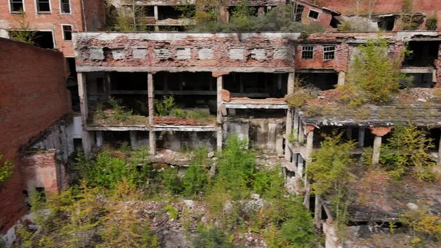 View from above. The camera flies past the abandoned plant of the Khrustalnensky mining and processing plant in the village of Khrustalny, Primorsky Territory. Abandoned tin mining plant