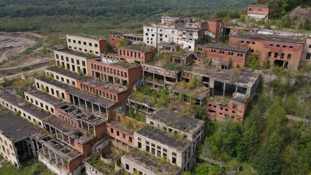 View from above. The camera flies past the abandoned plant of the Khrustalnensky mining and processing plant in the village of Khrustalny, Primorsky Territory. Abandoned tin mining plant