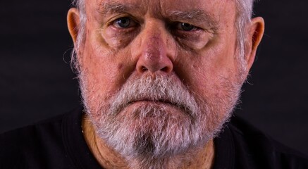 Old Senior Man With Scraggly Beard Looking At Camera