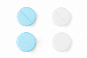 Set of white and blue pills isolated on white background. Top view