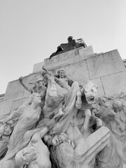 Black and white low angle view of scene sculpture detail of Monument to Giuseppe Mazzini in Piazzale Ugo La Malfa, Rome, Italy