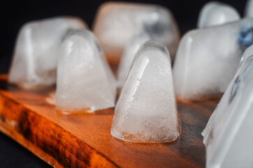 ice cubes on wooden floor selective focus