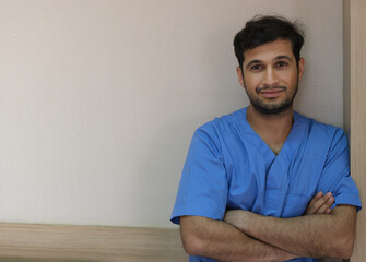 The male patient stood smiling after his illness improved.