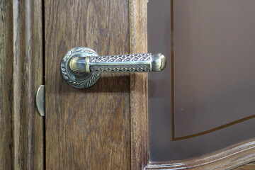 Picture of the door handle and the lock. Fragment of the door.