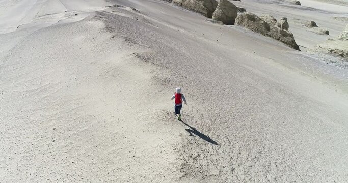 Aerial view of woman trail runner cross country running  on sand desert dunes