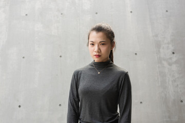 The face of a young lady frowning in the open air