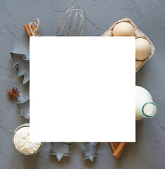 Christmas Baking background with eggs, flour, cookie cutters, milk on a concrete background. Delicious and healthy food. Flat lay. Top view. Place for text