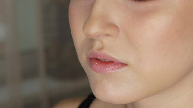 Make-up artist paints model's lips