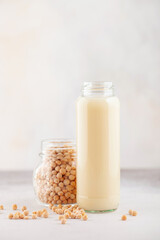Vegetable pea milk in a bottle and peas in a jar. Gluten free, lactose free product