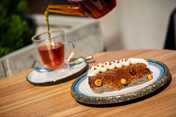 Fototapeta na wymiar tea and caramel cake on the summer terrace