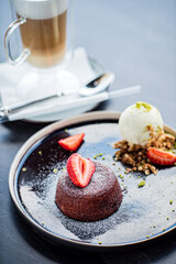 Chocolate fondant (cupcake) with strawberries and ice cream