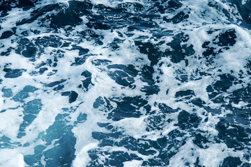      Blue sea water with bubbles and white foam.