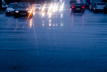 slow cars traffic in the city street during downpour. looking through car windshield. motion blur