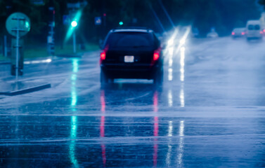 Fototapeta na wymiar car driving in the city street during a downpour. car traffic at rainy evening. motion blur