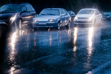 traffic jam in rainy night in the big city. cars on wet road