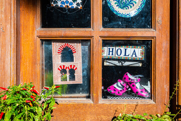 Granda, Spain. August 17th, 2019. Small wooden window decorated with various objects taken from the street in the center of Granada.