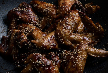 chicken in teriyaki sauce in a wok pan, top view