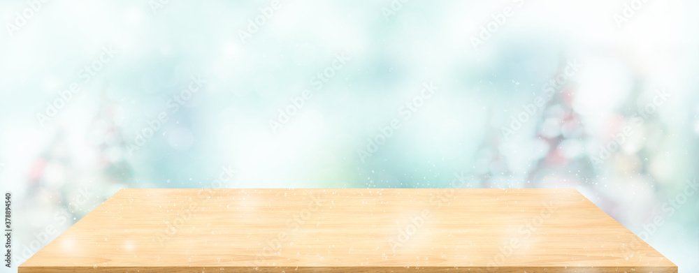 Leinwandbilder Perspective wood table with blur Christmas tree decorate string light and blue bokeh with snow light.Panoramic wooden countertop banner mock up for product display greeting card design online content