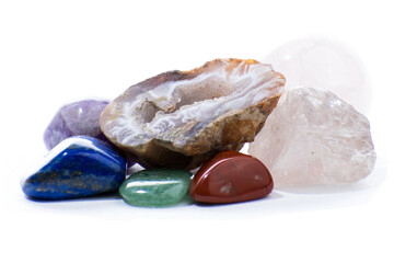 Collection of small polished gems and stones, with a quartz geode in the center.  Variety of colors...