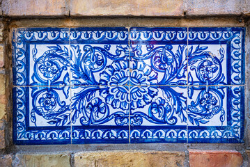 Seville, Spain. October 14th, 2020. Decorative ceramic tiles on the perimeter wall of the historic tobacco factory building on Calle San Fernando, now home to the university.