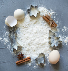 Christmas Baking background with eggs, flour, milk on a concrete background. Delicious and healthy food. Flat lay. Top view. Place for text