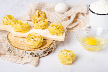 cooking tagliatelle on a white table