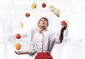 Young male chef juggles with food ingredients