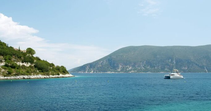 Beautiful landscape with green forest and emerald water lagoon of Foki Fiskardo beach, Kefalonia, Ionian islands, Greece.