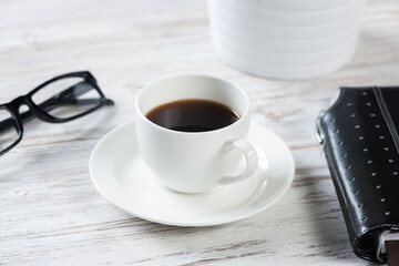 Top view office desk with white cup of coffee