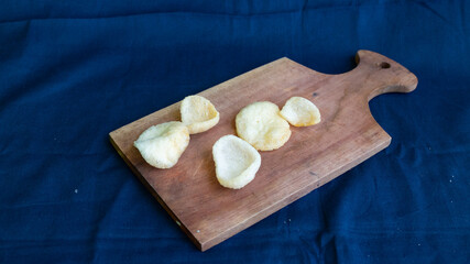Crackers or kerupuk on top Wooden base of a tray