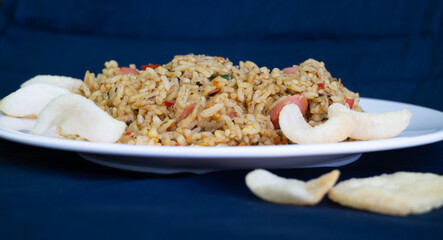 Nasi goreng or fried rice with sausage and crackers or kerupuk