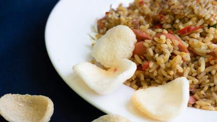 Nasi goreng or fried rice with sausage and crackers or kerupuk