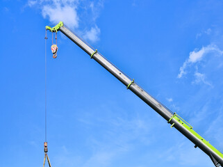 Obraz premium Isolated section of a heavy duty crane equipment lifting a container.