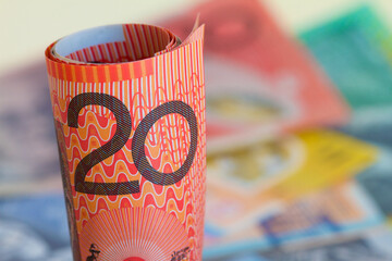 Australian twenty dollar notes rolled with a background of notes.