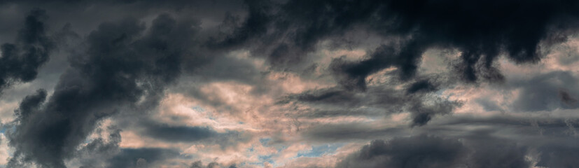 Fototapeta na wymiar Panorama of Dramatic cloudy sky during sunset. Magic evening dusk clouds.