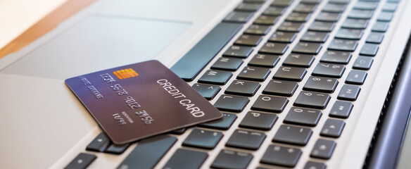 Banner image of credit card on computer keyboard. Online financial transaction for payment with...