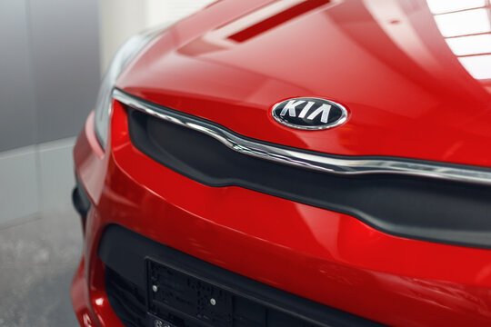 Tolyatti / Russia - 07.02.2020: Close up of KIA logo. New red car KIA, detail on the front of the car. The car is in the showroom