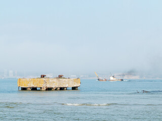 Rusty Bollard for barges on a concrete pier. Old rusty pier in the fog. Beautiful fog in the...