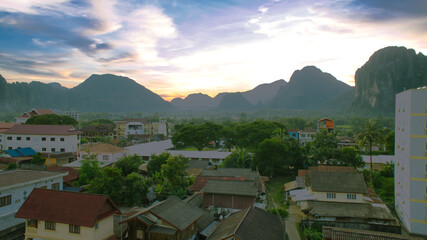 sunset over the mountains. Landscape of Vang Vieng District. Exterior View of House Roof in Vang Vieng District, Vientiane Province, Laos.