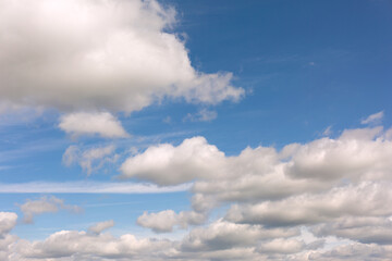 White clouds on blue sky background.