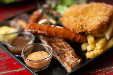 top view of mix steak with and fresh green herb salad and dragon fruit on vintage wooden table