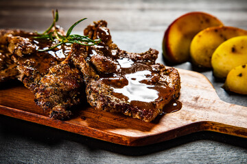 Barbecue pork neck with apples on wooden board