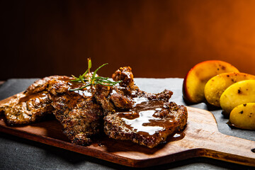 Barbecue pork neck with apples on wooden board
