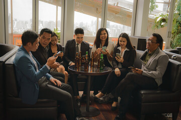 businesspeople clinking bottle of beer and talking together