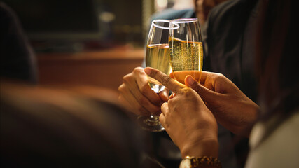 hands toasting wine or champagne together to celebrate friendship