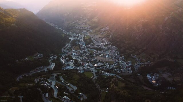 Parallax aerial view of small town in the shadow valley of Pyrenees mountains, Encamp, Andorra