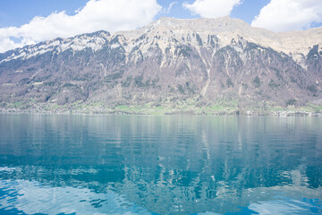 Beautiful lake in Swiss Alps in a sunny spring day with reflections in the lake water, bright colourful lake water