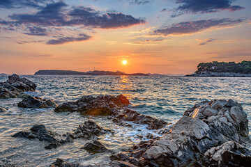 Sunset over rocky beach